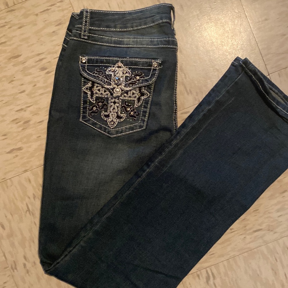 Earl Jean size 10, bootcut, & silver embellishments on front and back pockets.